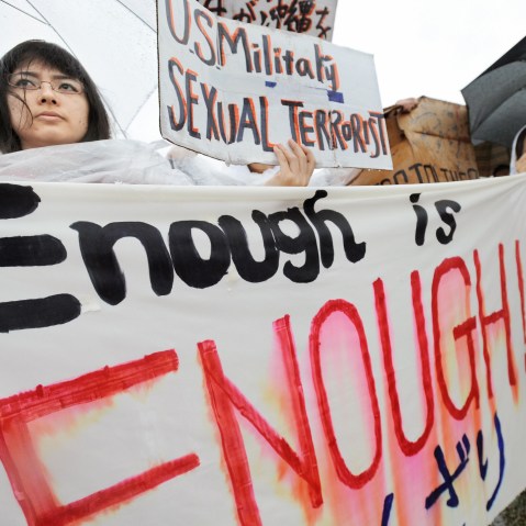 Young Japanese women hold banners during a major rally against the US military at a park in Okinawa after a string of serious misconduct by its soldiers including alleged rapes in the Japan's southern island province on March 23, 2008. More than 6,000...