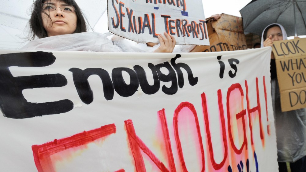 Young Japanese women hold banners during a major rally against the US military at a park in Okinawa after a string of serious misconduct by its soldiers including alleged rapes in the Japan's southern island province on March 23, 2008. More than 6,000...