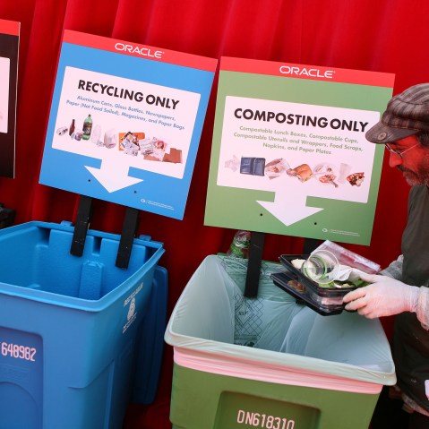 A worker separates recyclables and compost materials at the Oracle Open World conference September 22, 2008 at the Moscone Center in San Franciscso, Calif.