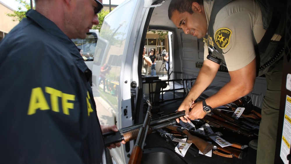 File Photo: Officers load some of about 125 weapons confiscated during what the federal authorities say is the largest gang takedown in U.S. history into a van after a press conference to announce the arrests of scores of alleged gang members and...