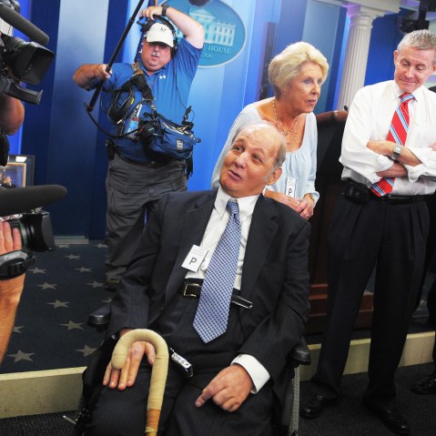 James Brady (C), former White House press secretary for president Ronald Reagan, and his wife Sarah (3rd L) chat with journalists, June 16, 2009.