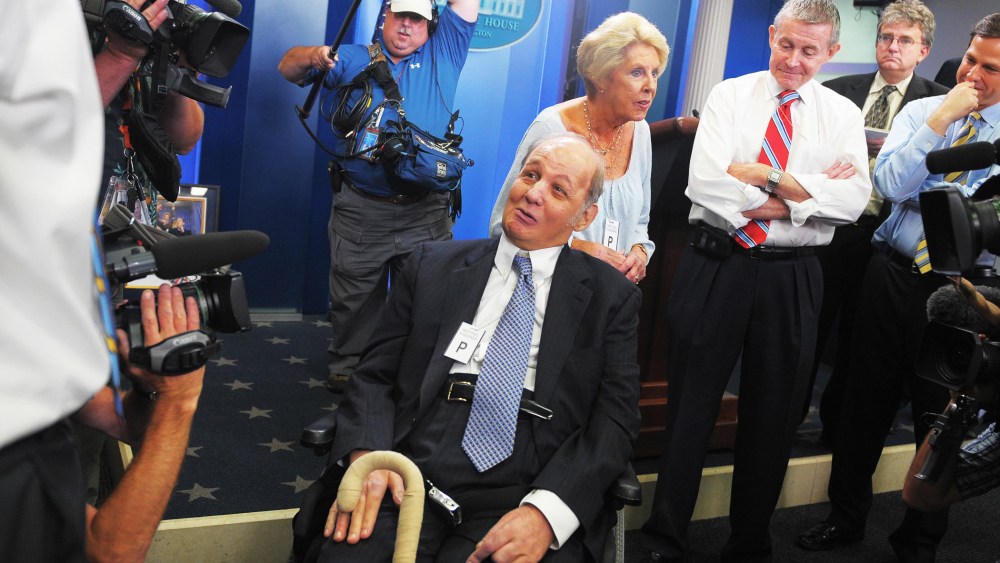 James Brady (C), former White House press secretary for president Ronald Reagan, and his wife Sarah (3rd L) chat with journalists, June 16, 2009.