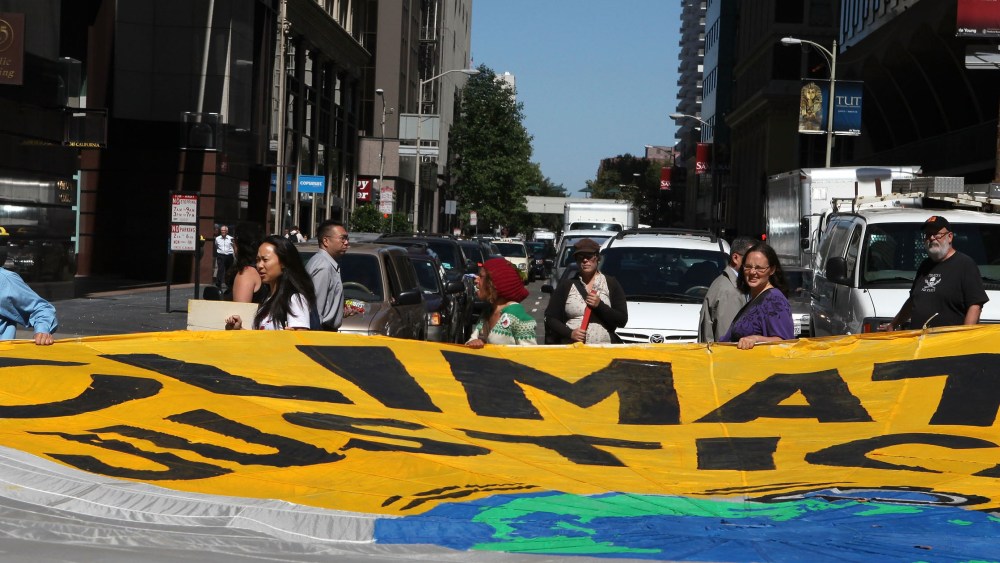 File Photo: Demonstrators block an intersection with a large banner as they protest the climate and energy bill that is currently before congress September 21, 2009 in San Francisco, California.(Photo by Justin Sullivan/Getty Images, File)