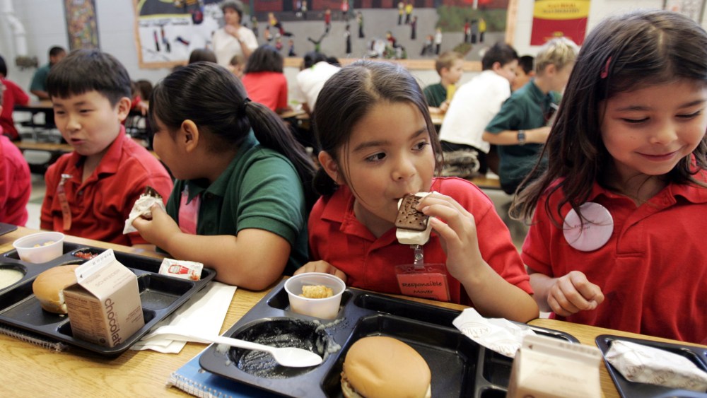 Elena Serrano, 7, second right, eats an ice cream sandwich during lunch at the Four Seasons Elementary School in St. Paul, Minn., June 29, 2006.