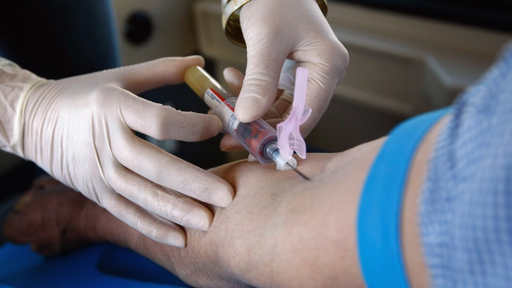 A health worker draws blood from a patient in Denver, Colorado.