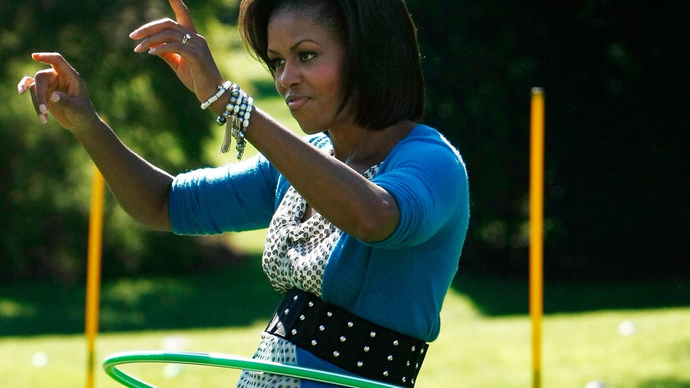 File Photo: U.S. first lady Michelle Obama hula hoops on the South Lawn of the White House during an event promoting exercise and healthy eating for children October 21, 2009.  (Photo by Win McNamee/Getty Images, File)