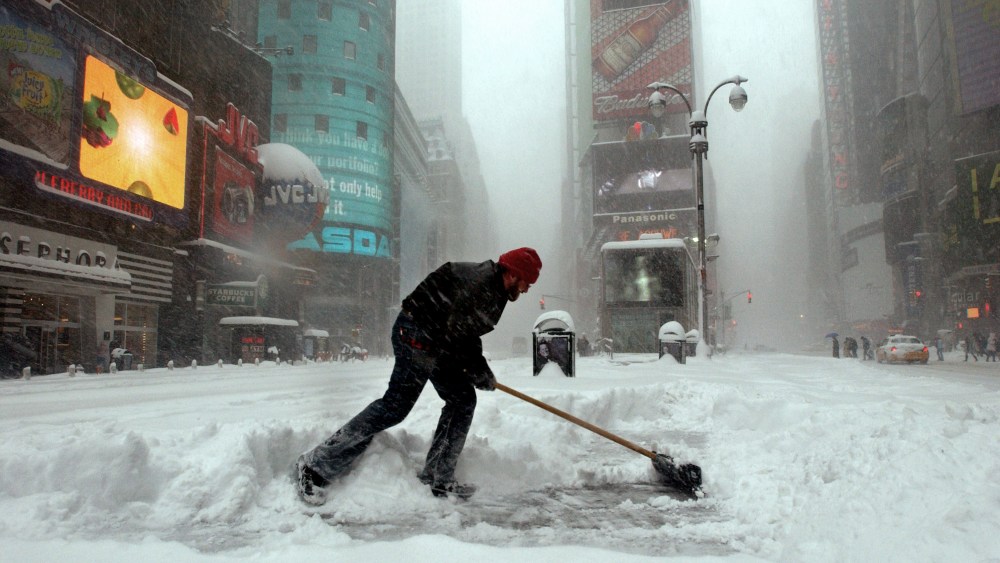 An identified man clears the snow in the center island in Times Square during a heavy blizzard, Feb. 12, 2006 in New York City. (Photo by Ramin Talaie/Bloomberg News)