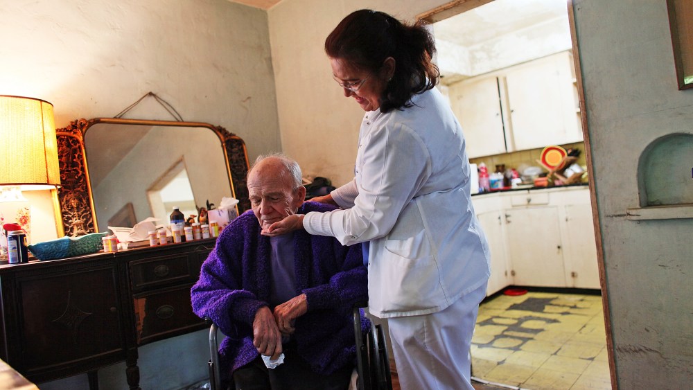 United HomeCare Services home health aide Wendy Cerrato visits with Robert Granville as she washes and feeds him in Miami, Florida.
