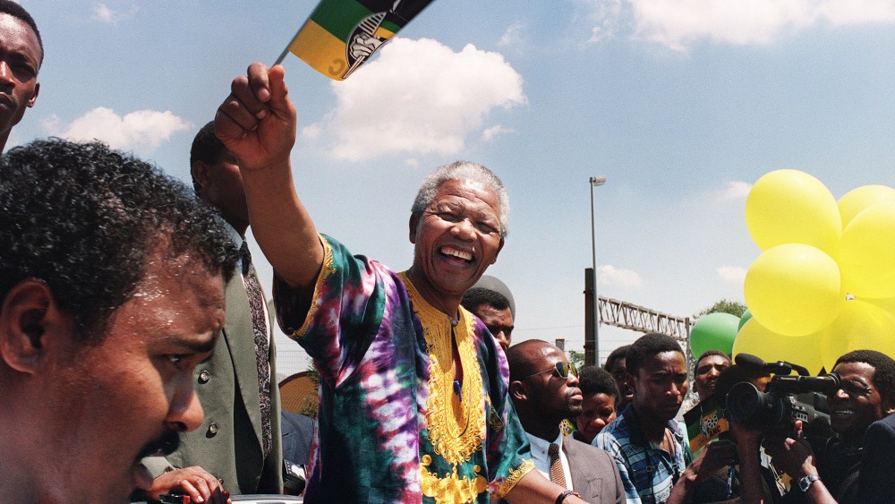 Nelson Mandela waves to supporters while campaigning for the presidential election, Jan. 29, 1994.