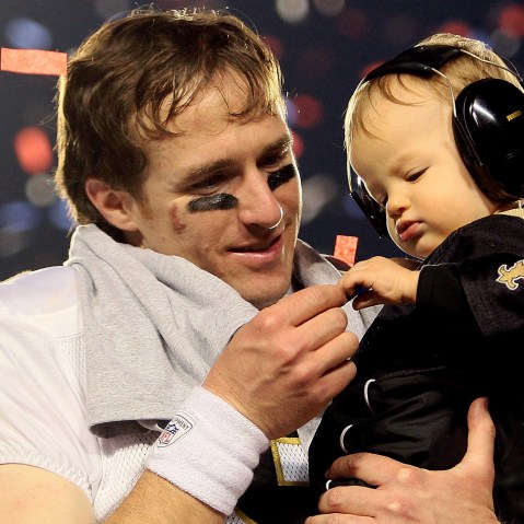 Drew Brees #9 of the New Orleans Saints celebrates with his son Baylen Brees after defeating the Indianapolis Colts during Super Bowl XLIV on February 7, 2010 in Miami Gardens, Fla.