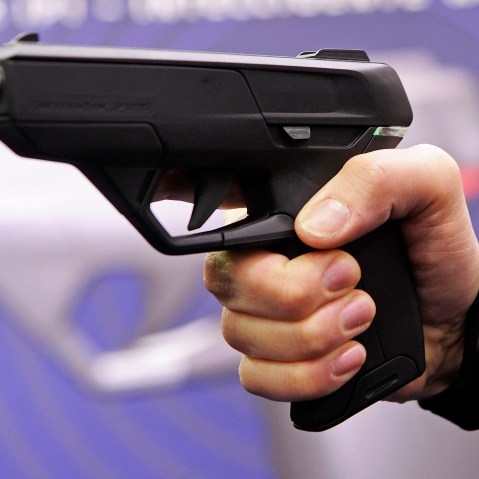 An employee of Armatix poses for photographers as he presents the "SmartGun Concept".