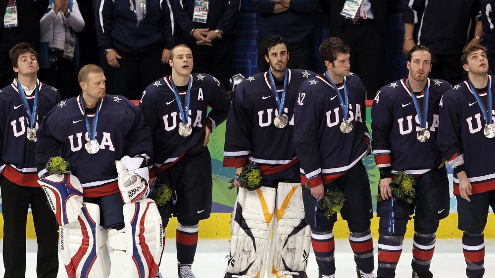 Members of the USA hockey team look on dejectedly after receiving their silver medals following their 3-2 overtime loss to Canada, Feb. 28, 2010.