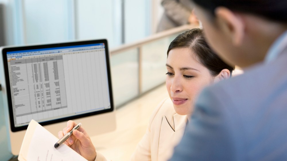 Businesswoman reviewing co-worker. (Stock Photo by Robert Nicholas/OJO Images/Getty Images)