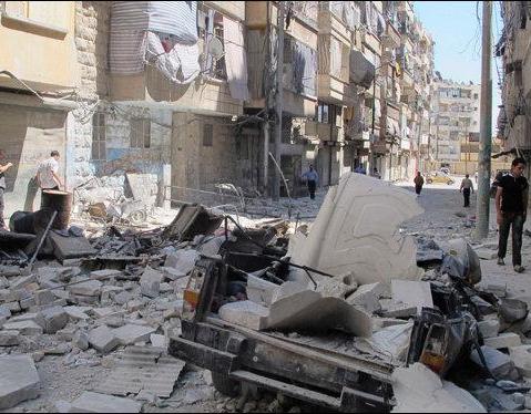 A damaged vehicle is seen after shelling by forces loyal to President Bashar al-Assad in Aleppo's district of Bustan Al Qasr August 7, 2012.