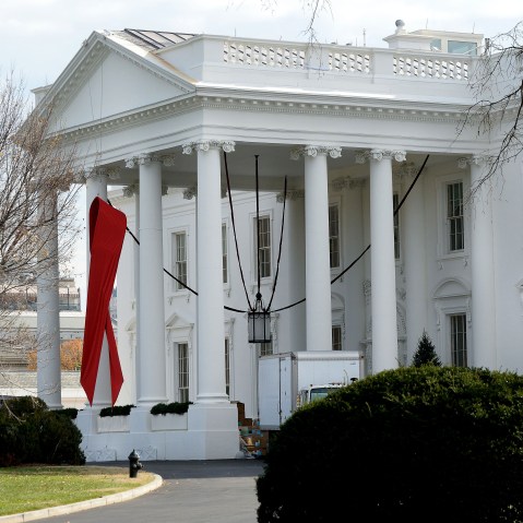 A red ribbon is displayed on the North Portico of the White House, December 1, 2014, to commemorate World AIDS Day.