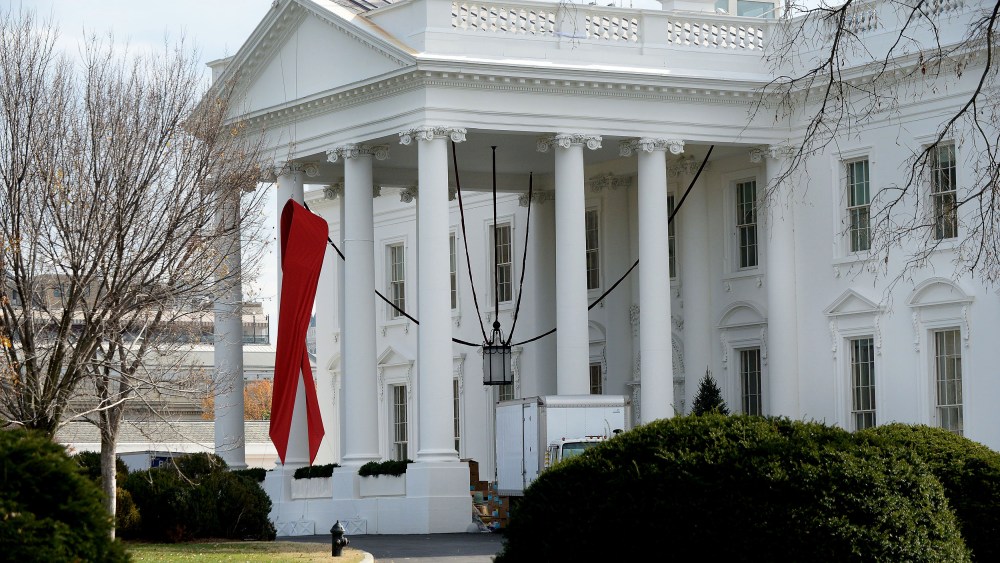 A red ribbon is displayed on the North Portico of the White House, December 1, 2014, to commemorate World AIDS Day.