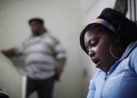 File Photo: Davida Johnson, 30, seen with her husband Bobby Johnson, reacts as she reads a grand jury report brought to her by the Associated Press during an interview in Philadelphia. Johnson believes she contracted a venereal disease while undergoing...