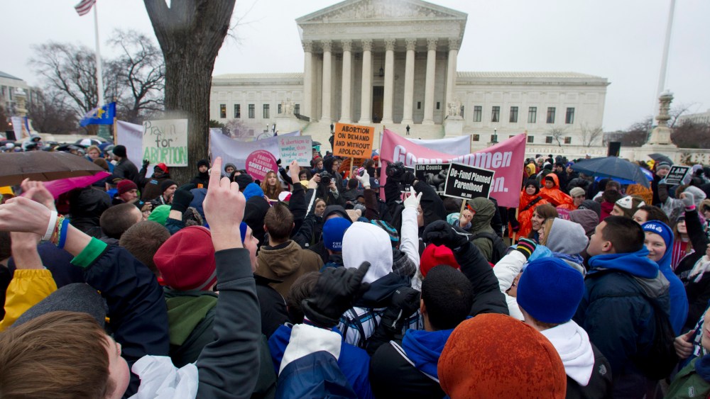 Anti-abortion and abortion rights supporters stand face to face in front of the Supreme Court in Washington, Monday, Jan. 23, 2012, during the annual March For Life rally.  (AP Photo/Manuel Balce Ceneta)