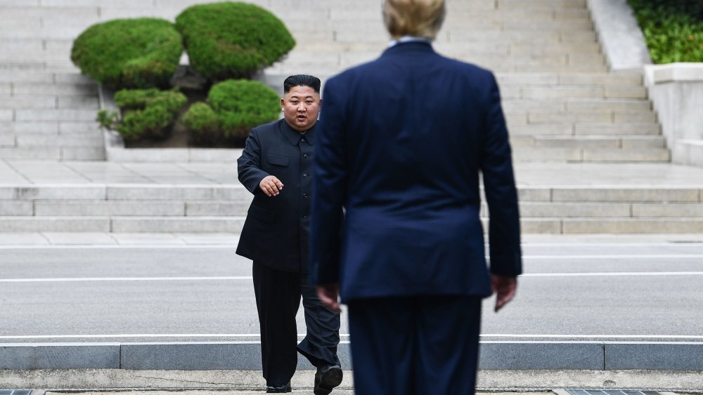 North Korea's leader Kim Jong Un walks to greet Donald Trump at the Military Demarcation Line that divides North and South Korea, in the Joint Security Area (JSA) of Panmunjom in the Demilitarized zone (DMZ) on June 30, 2019.