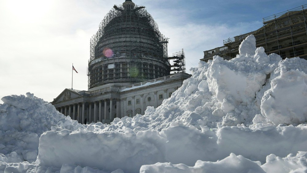 The U.S. Capitol rises above a large mound of snow cleared from the East Front on Jan. 25, 2016 in Washington, D.C. (Photo by Mandel Ngan/AFP/Getty)