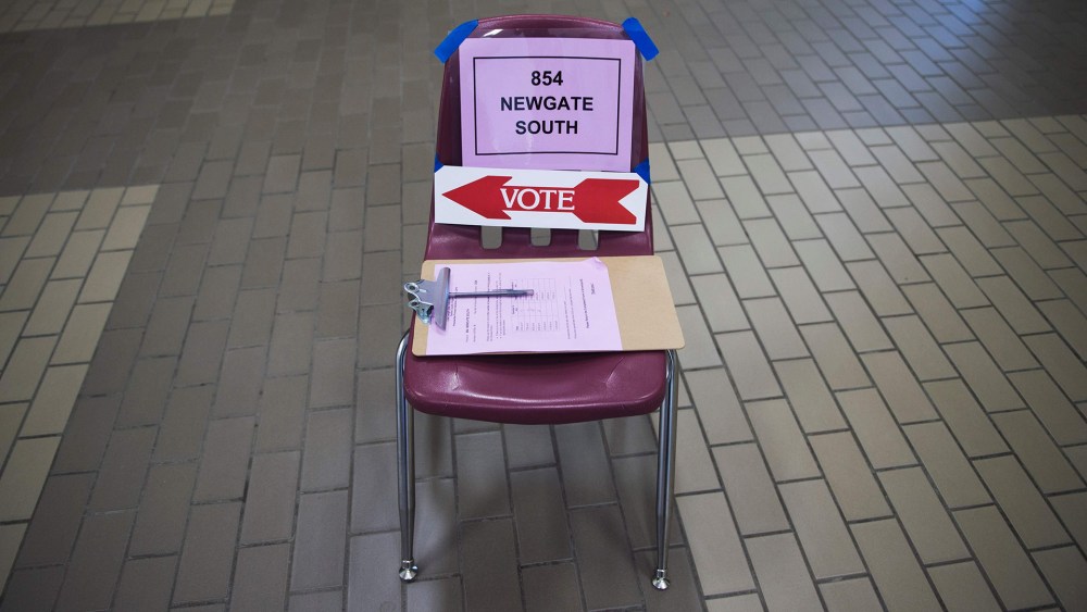 Signs are seen on a chair to assist voters at Centreville High School in Centreville, Va., March 1, 2016, during the Super Tuesday primary voting. (Photo by Paul J. Richards/AFP/Getty)