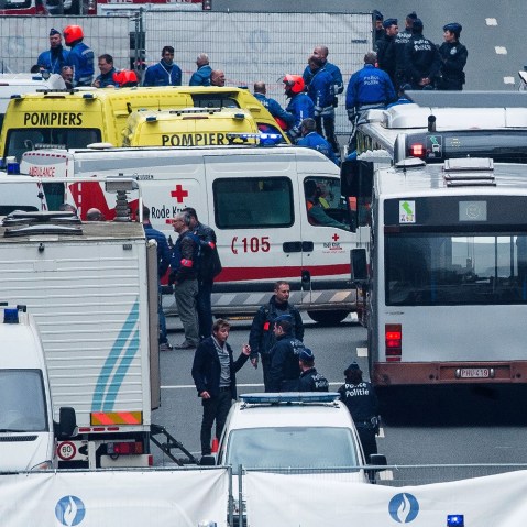 Belgian police officers and rescue workers gather on the Wetstraat (Rue de la Loi) which was evacuated after an explosion at the Maalbeek subway station in Brussels on March 22, 2016. (Photo by Laurie Dieffembacq/AFP/Getty)
