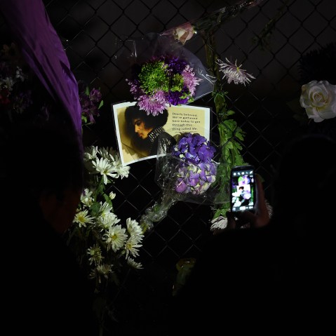Fans pay their respects outside the Paisley Park residential compound of music legend Prince in Minneapolis, Minn., on April 21, 2016. (Photo by Mark Ralston/AFP/Getty)