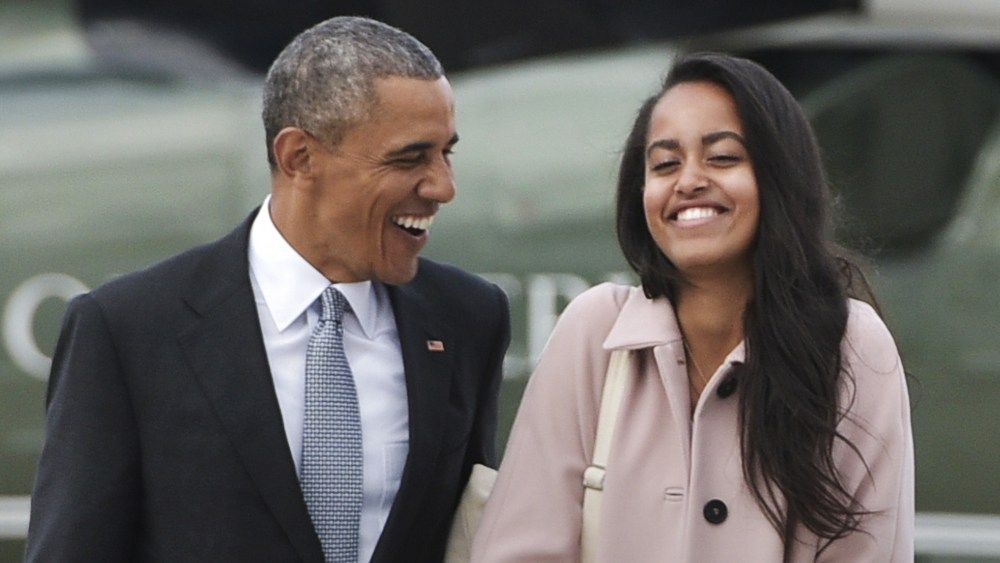 This file photo taken on April 7, 2016 shows President Barack Obama and daughter Malia make their way to board Air Force One. (Photo by Mandel Ngan/AFP/Getty)