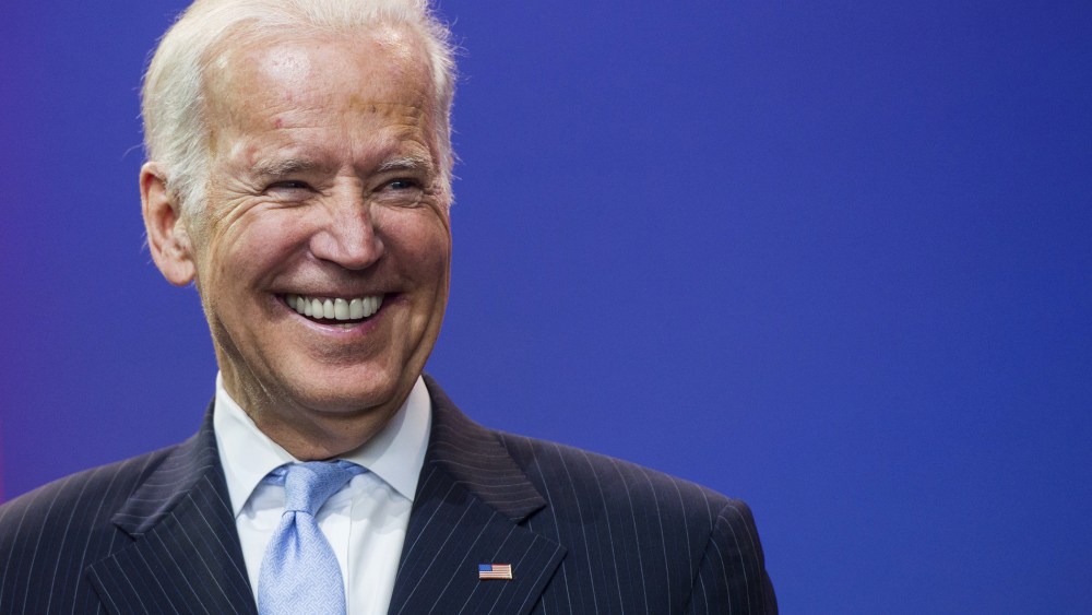Vice President Joe Biden laughs during a celebration of the 5th anniversary of Joining Forces and the 75th anniversary of the USO at Andrews Air Force Base in Md., May 5, 2016. (Photo by Saul Loeb/AFP/Getty)