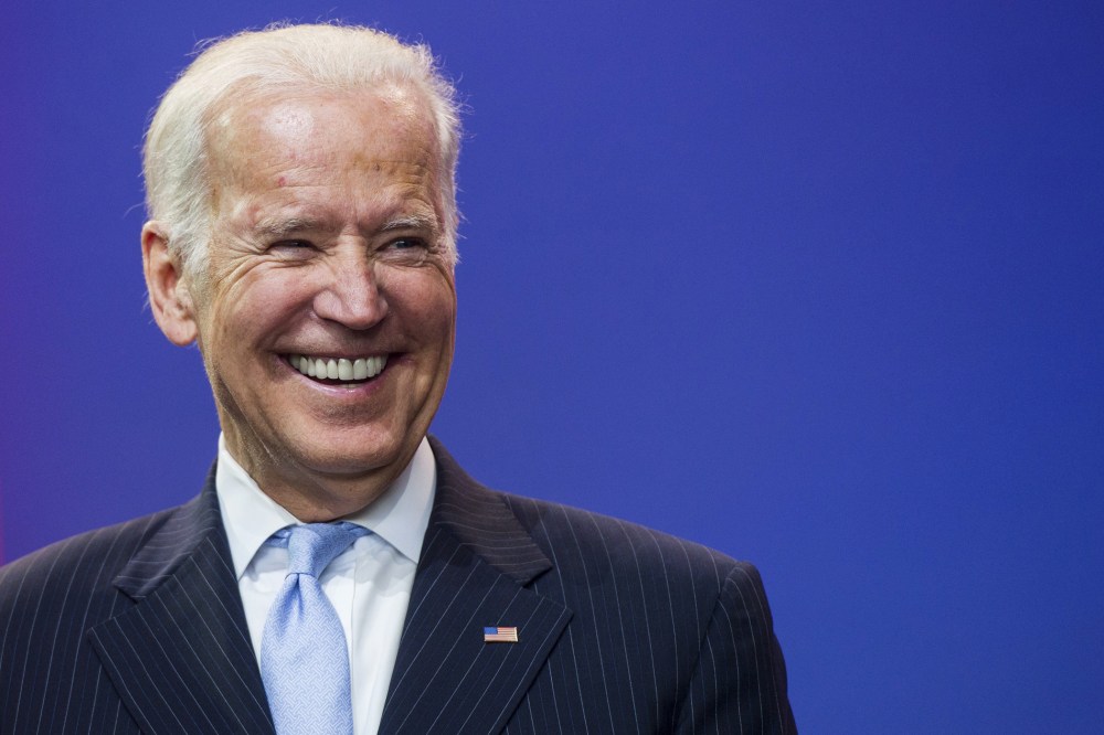 Vice President Joe Biden laughs during a celebration of the 5th anniversary of Joining Forces and the 75th anniversary of the USO at Andrews Air Force Base in Md., May 5, 2016. (Photo by Saul Loeb/AFP/Getty)