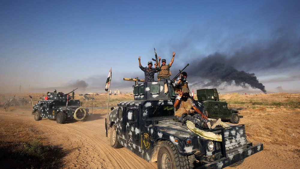 Iraqi pro-government forces advance towards the city of Fallujah on May 23, 2016, as part of a major assault to retake the city from Islamic State (IS) group. (Photo by Ahmad Al-Rubaye/AFP/Getty)