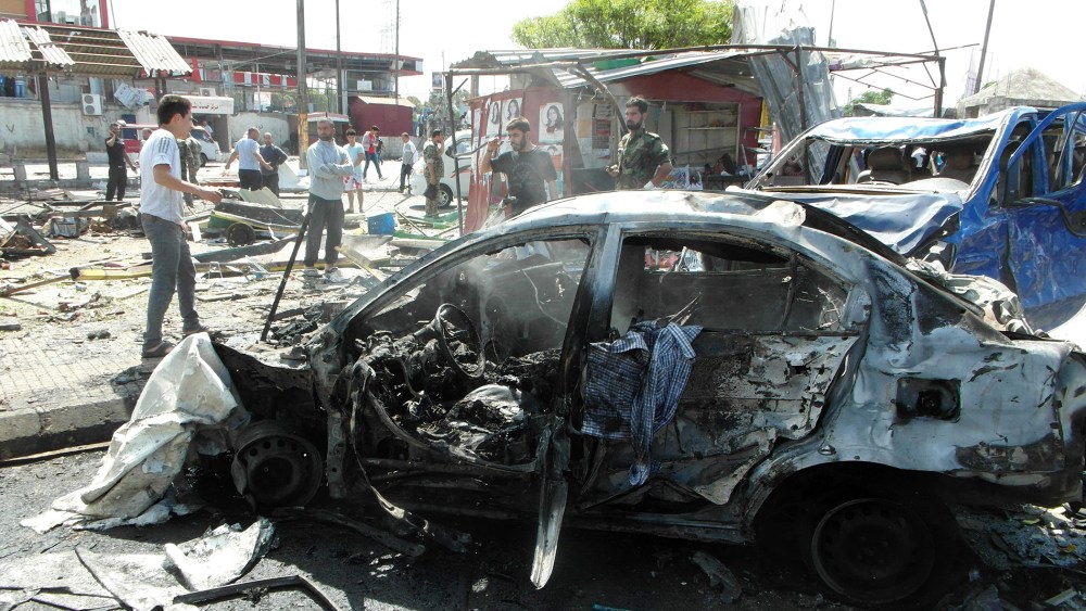Syrians gather at the site of multiple bombings that left tens dead in the northern coastal city of Jableh, between Latakia and Tartus on May 23, 2016. (Photo by AFP/Getty)