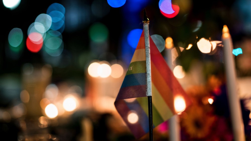 A gay pride flag is seen at a memorial after a vigil outside the Dr. Phillips Center for the Performing Arts for the mass shooting victims at the Pulse nightclub June 13, 2016 in Orlando, Fla. (Photo by Brendan Smialowski/AFP/Getty)