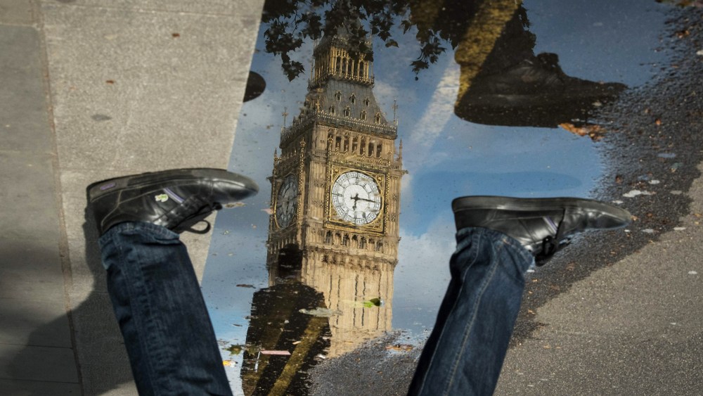 The Queen Elizabeth Tower (Big Ben) is reflected in a puddle as a man walks by on June 27, 2016 in London, England. (Photo by Leon Neal/AFP/Getty)