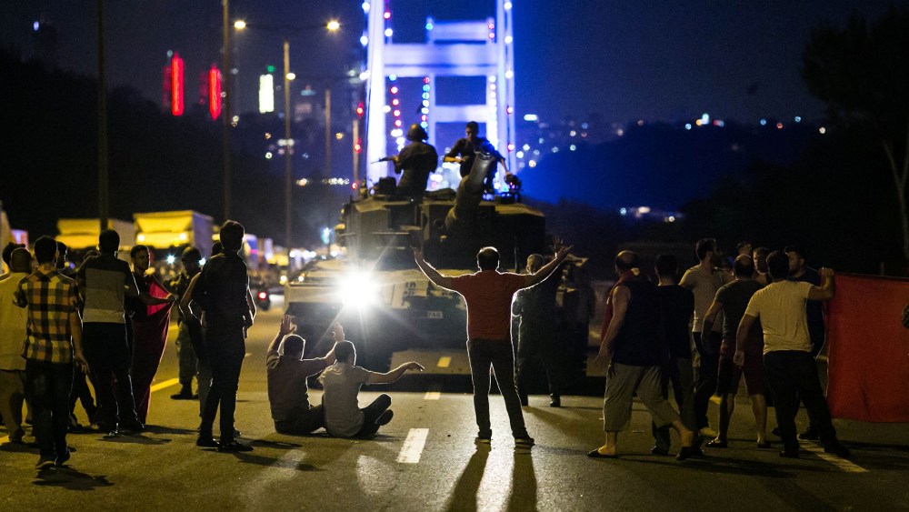People take over a tank near the Fatih Sultan Mehmet bridge during clashes with military forces in Istanbul on July 16, 2016. (Photo by Gurkan Ozturk/AFP/Getty)