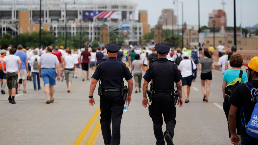 Police officers walk among people marching to join hands in a peace rally amid preparations for the arrival of visitors and delegates for the Republican National Convention on July 17, 2016, in Cleveland, Ohio. (Photo by Dominick Reuter/AFP/Getty)
