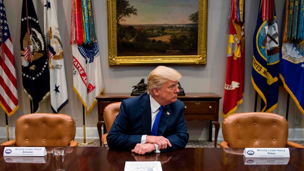 U.S. President Donald Trump makes a statement from the Roosevelt Room next to the empty chairs of Senate Minority Leader Chuck Schumer (L), D-New York, and House Minority Leader Nancy Pelosi (R), D-California, after they cancelled their meeting at the Whi