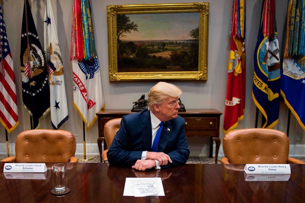 U.S. President Donald Trump makes a statement from the Roosevelt Room next to the empty chairs of Senate Minority Leader Chuck Schumer (L), D-New York, and House Minority Leader Nancy Pelosi (R), D-California, after they cancelled their meeting at the Whi