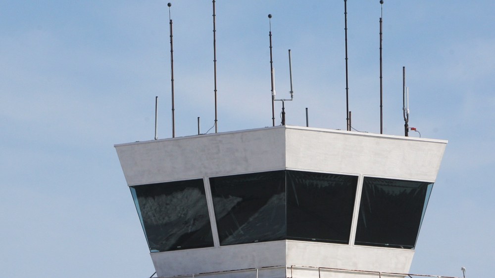 A twin engine airplane flies by the tower at St. Louis Regional Airport in Bethalto, Ill., Monday Feb. 25, 2013, before circling to land. The airport is one of 100 airports nationwide with less than 150,000 annual flights that will likely loose their...