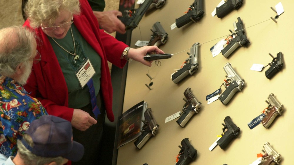 Visitors view a handgun display at the National Rifle Association convention Saturday, April 17, 2004, in Pittsburgh, Pennsylvania.