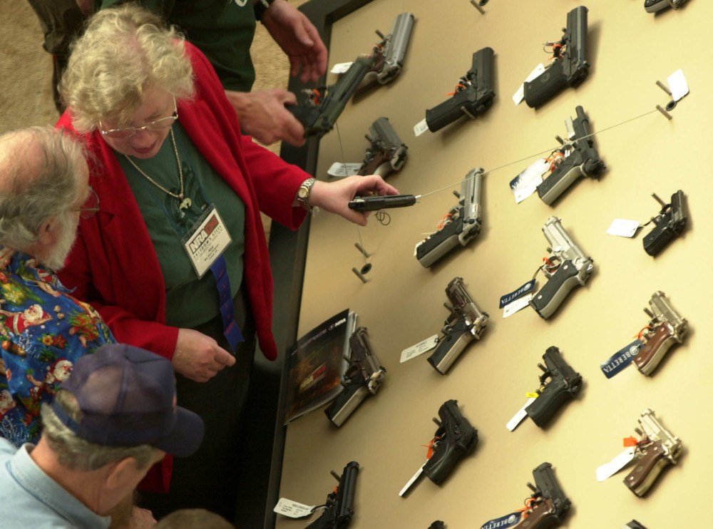 Visitors view a handgun display at the National Rifle Association convention Saturday, April 17, 2004, in Pittsburgh, Pennsylvania.