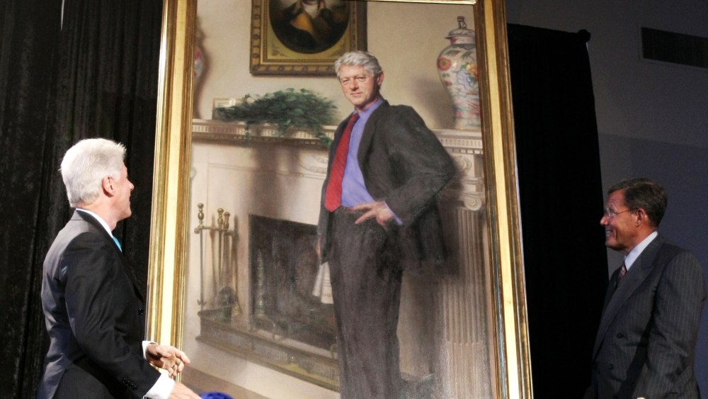 Former President Bill Clinton, left, looks up at his portrait after Lawrence M. Small, secretary of the Smithsonian Institution, right, helped him remove the drape, April 24, 2006, in Washington, D.C. (Photo by Haraz N. Ghanbari/AP)