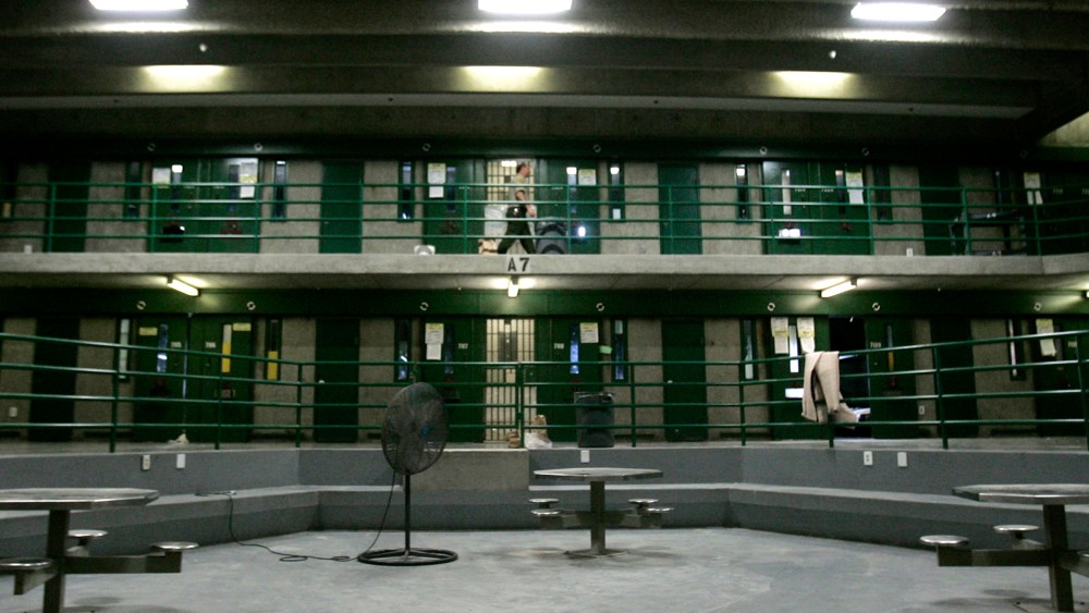 Correctional Officer Max Nelson makes the rounds, every 30 minutes, checking on inmates in the segregation unit for suicide attempts, at California State Prison, Sacramento, in Folsom, Calif., March 30, 2007. (Photo by Rich Pedroncelli/AP)