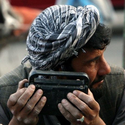 An Afghan man searches the waves of a radio to hear the tim efor breaking his daily ramadan fast in the city of Kabul, Afghanistan, Sep. 24, 2007. (Photo by Musadeq Sadeq/AP)