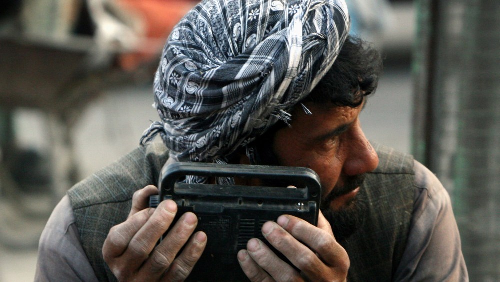 An Afghan man searches the waves of a radio to hear the tim efor breaking his daily ramadan fast in the city of Kabul, Afghanistan, Sep. 24, 2007. (Photo by Musadeq Sadeq/AP)