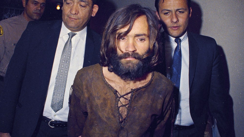 Charles Manson is escorted to his arraignment on conspiracy-murder charges in connection with the Sharon Tate murder case in 1969 in Los Angeles, Calif.