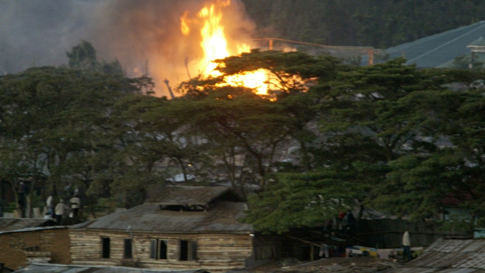 Flames are seen in the Kibera slums, Sunday, Dec. 30, 2007, after violence broke out after President Mwai Kibaki was declared the winner of presidential elections.  Elections chief Samuel Kivuitu, who read the result on live television after other...