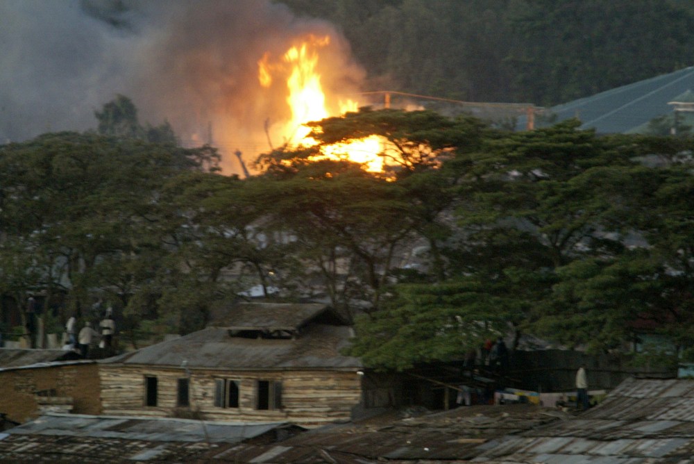 Flames are seen in the Kibera slums, Sunday, Dec. 30, 2007, after violence broke out after President Mwai Kibaki was declared the winner of presidential elections. Elections chief Samuel Kivuitu, who read the result on live television after other...