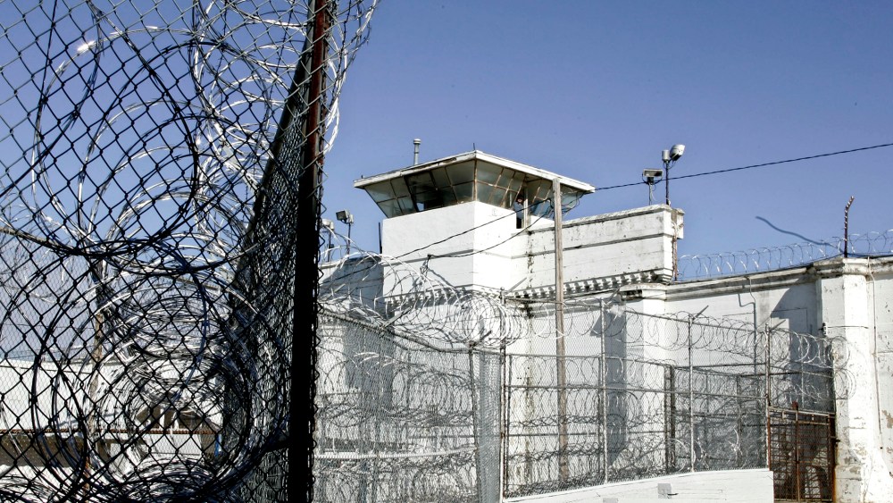 A guard tower and razor wire at the Oklahoma State Penitentiary in McAlester, Okla.