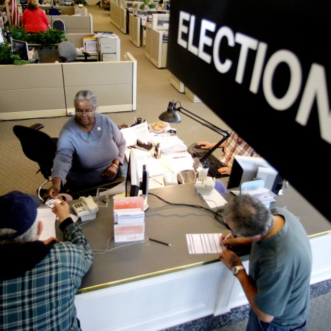 Voters drop their voters registration at Multnomah County Elections Office on Oct. 14, 2008, in Portland, Ore., on the final day for voter registration in Oregon. (Photo by Rick Bowmer/AP)